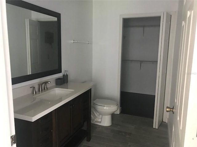bathroom featuring vanity, toilet, and hardwood / wood-style floors