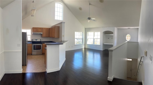 kitchen featuring high vaulted ceiling, appliances with stainless steel finishes, dark hardwood / wood-style floors, and ceiling fan