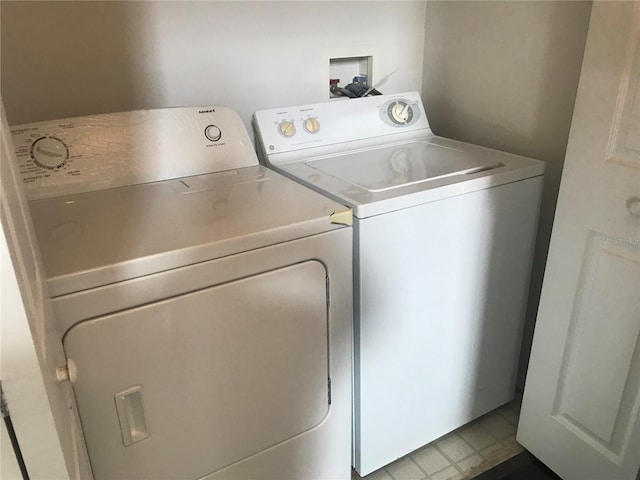 clothes washing area with washing machine and dryer