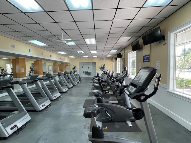 exercise room with concrete flooring and a drop ceiling