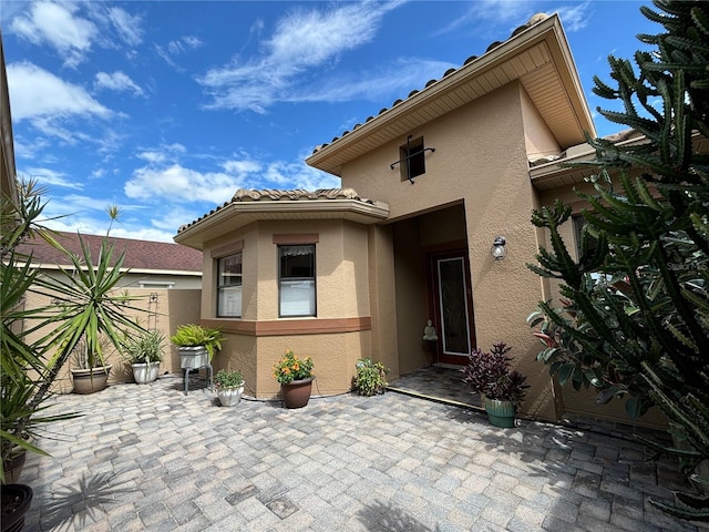 entrance to property with a patio