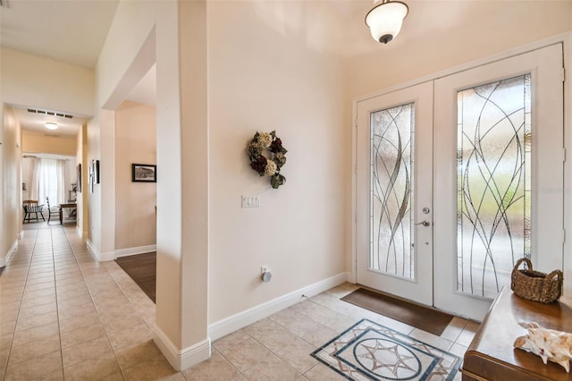 entrance foyer with french doors and light tile patterned flooring