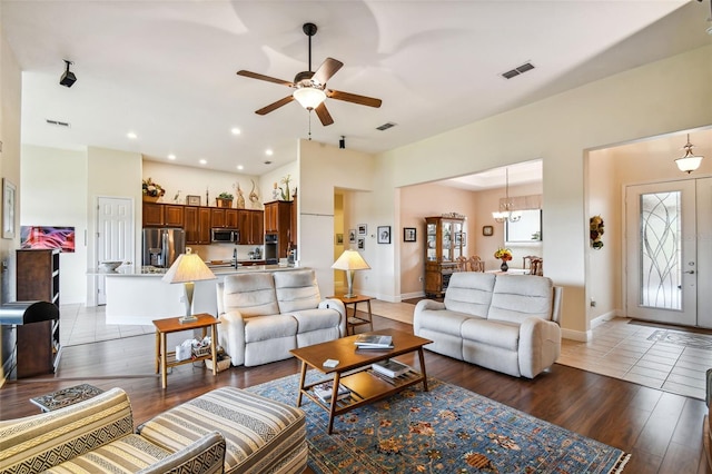 tiled living room featuring a healthy amount of sunlight and ceiling fan