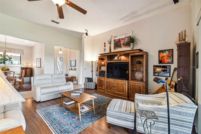 living room featuring ceiling fan and dark hardwood / wood-style flooring