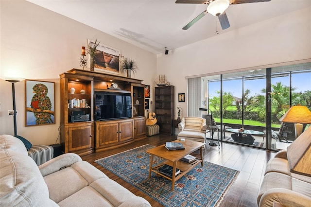 living room with dark wood-type flooring and ceiling fan