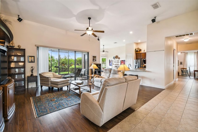 living room featuring tile patterned flooring and ceiling fan