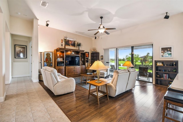 tiled living room featuring ceiling fan