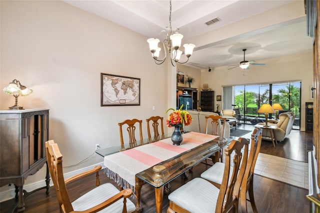 dining room featuring ceiling fan with notable chandelier and dark wood-type flooring