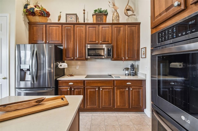 kitchen featuring light tile patterned floors and stainless steel appliances