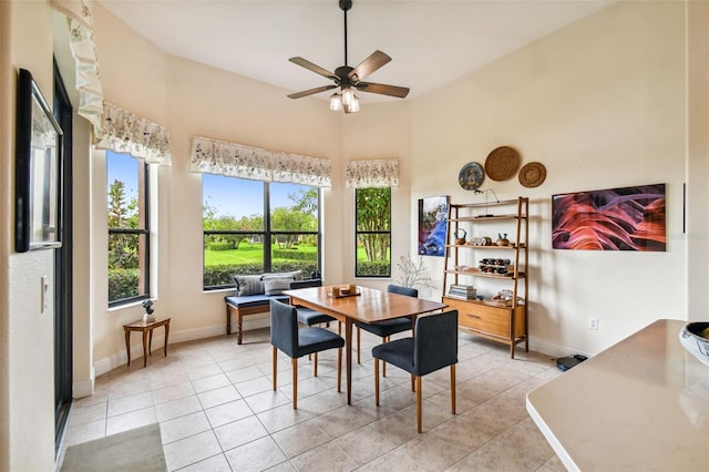 tiled dining space featuring ceiling fan