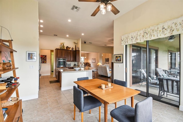 tiled dining area with ceiling fan