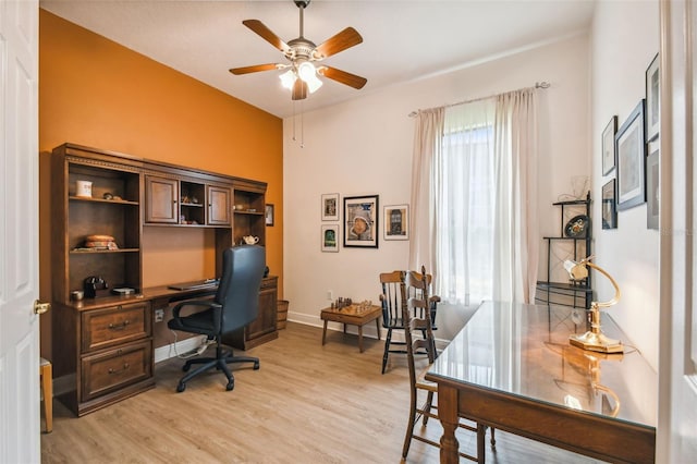 office with ceiling fan and light hardwood / wood-style flooring