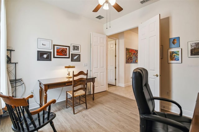 home office with ceiling fan and light hardwood / wood-style flooring