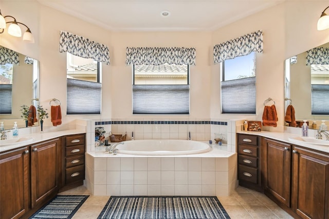 bathroom featuring vanity, tile patterned flooring, and tiled bath