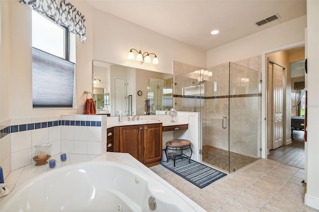 bathroom with wood-type flooring, independent shower and bath, and vanity