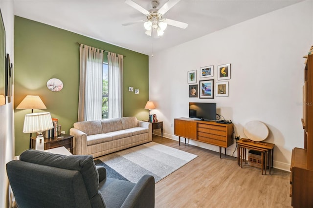 living room featuring light wood-type flooring and ceiling fan