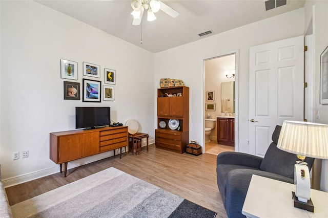 living room featuring ceiling fan and light hardwood / wood-style floors