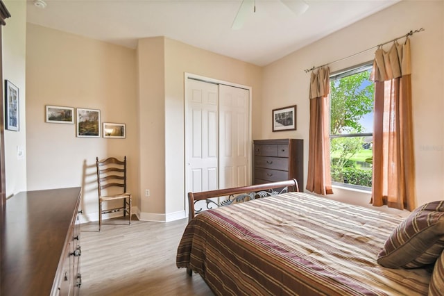 bedroom with hardwood / wood-style floors, ceiling fan, and a closet