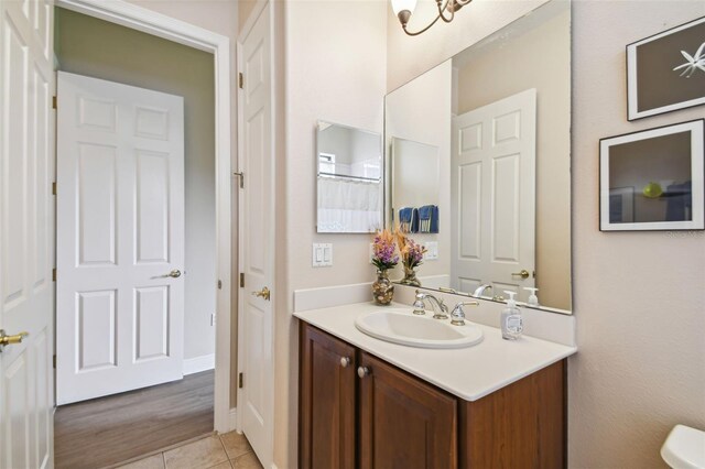 bathroom featuring hardwood / wood-style floors, toilet, and vanity