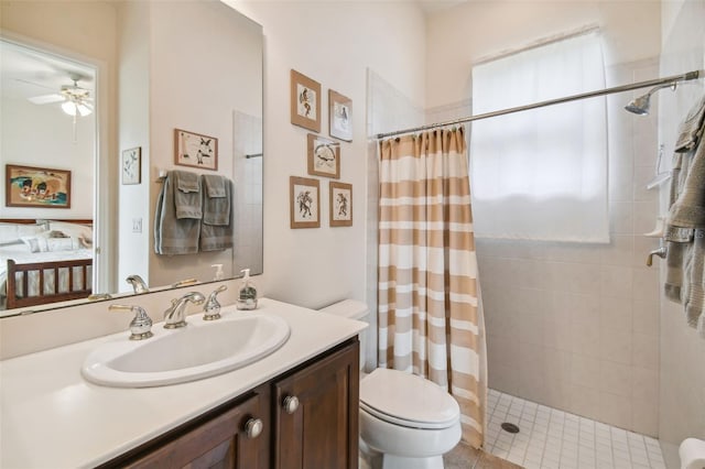 bathroom with vanity, toilet, a shower with shower curtain, and ceiling fan