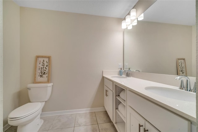 bathroom with vanity, tile patterned flooring, and toilet