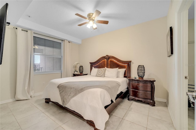 bedroom featuring light tile patterned floors, a ceiling fan, and baseboards