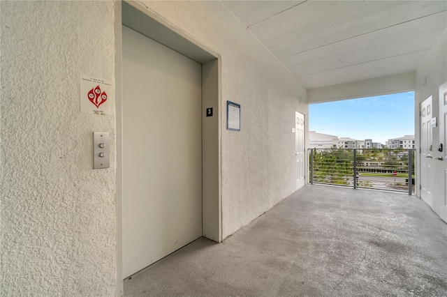 interior space with a balcony and elevator