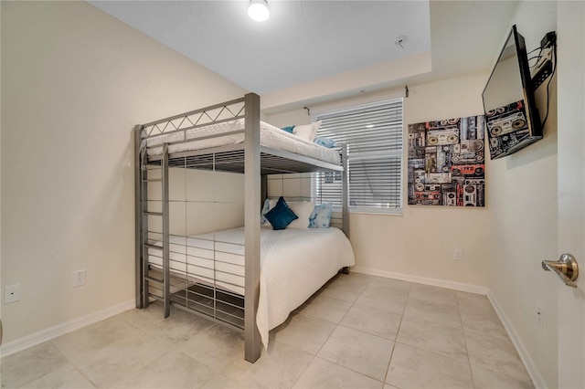 bedroom featuring tile patterned floors and baseboards