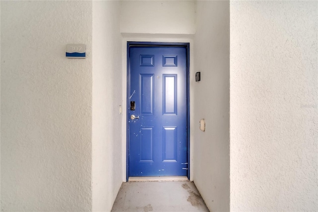 property entrance with stucco siding