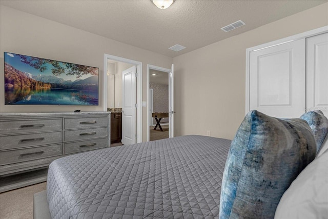 carpeted bedroom with a textured ceiling