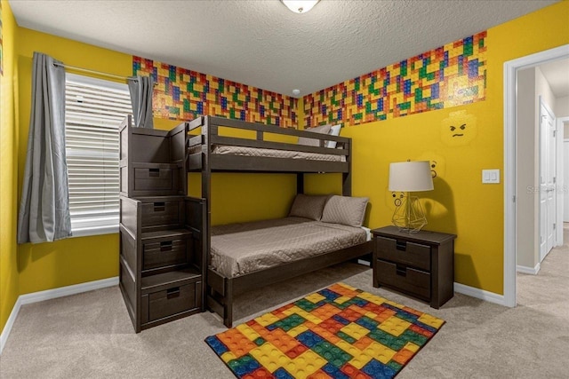 bedroom featuring a textured ceiling and light carpet