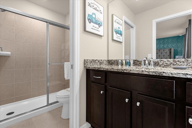 bathroom with an enclosed shower, tile patterned floors, toilet, and vanity