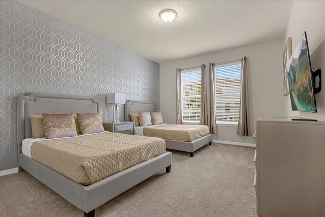 bedroom with light colored carpet and a textured ceiling