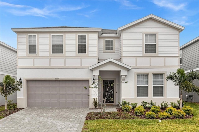 view of front of house featuring a garage and a front lawn