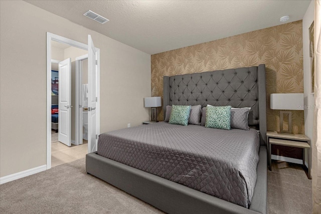 carpeted bedroom featuring a textured ceiling