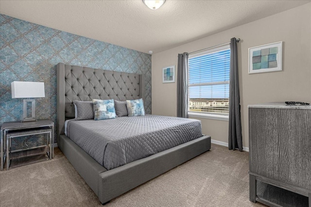 bedroom with light colored carpet and a textured ceiling