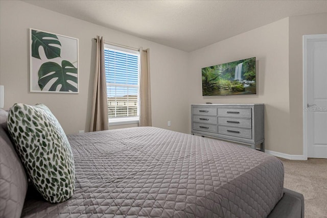 bedroom featuring a textured ceiling and carpet