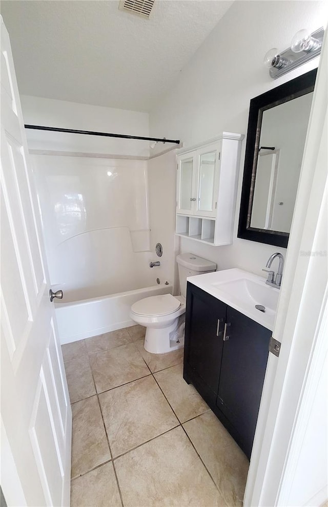 bathroom with toilet, tub / shower combination, a textured ceiling, vanity, and tile patterned floors