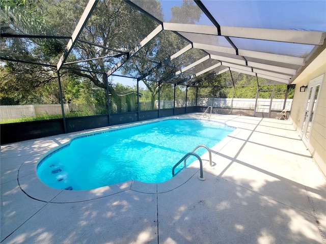 view of swimming pool featuring a lanai, a patio area, a fenced backyard, and a fenced in pool