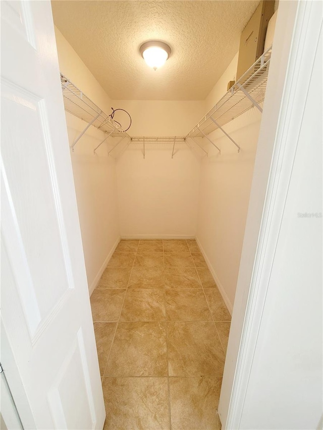 spacious closet with light tile patterned flooring