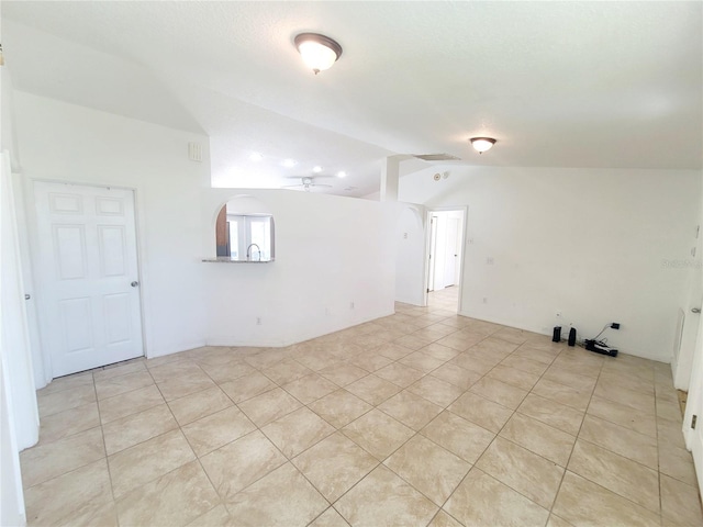 unfurnished room with ceiling fan, visible vents, vaulted ceiling, and arched walkways