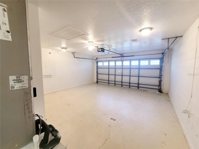 garage with concrete block wall and a garage door opener