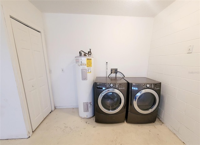 laundry area with laundry area, separate washer and dryer, and electric water heater