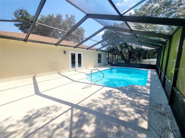 view of swimming pool featuring a fenced in pool, french doors, a patio area, and a lanai