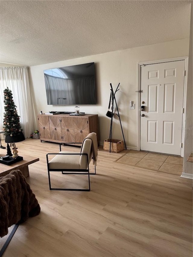 living room with wood-type flooring and a textured ceiling