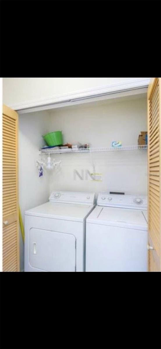 clothes washing area featuring separate washer and dryer