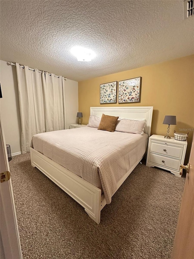 carpeted bedroom with a textured ceiling