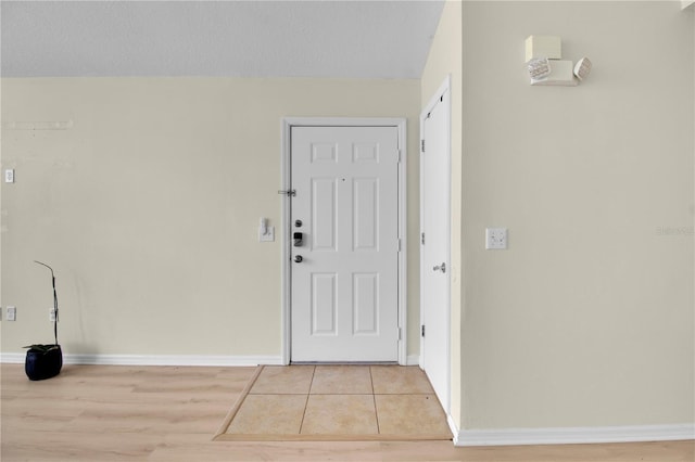 interior space featuring baseboards and light wood-style flooring