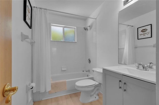 bathroom featuring toilet, vanity, wood finished floors, and shower / bath combo with shower curtain