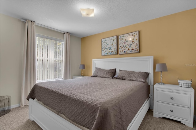bedroom featuring baseboards and carpet